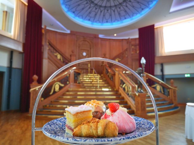 Tasty cakes for afternoon tea in front of the Grand Staircase at the Titanic Museum Belfast